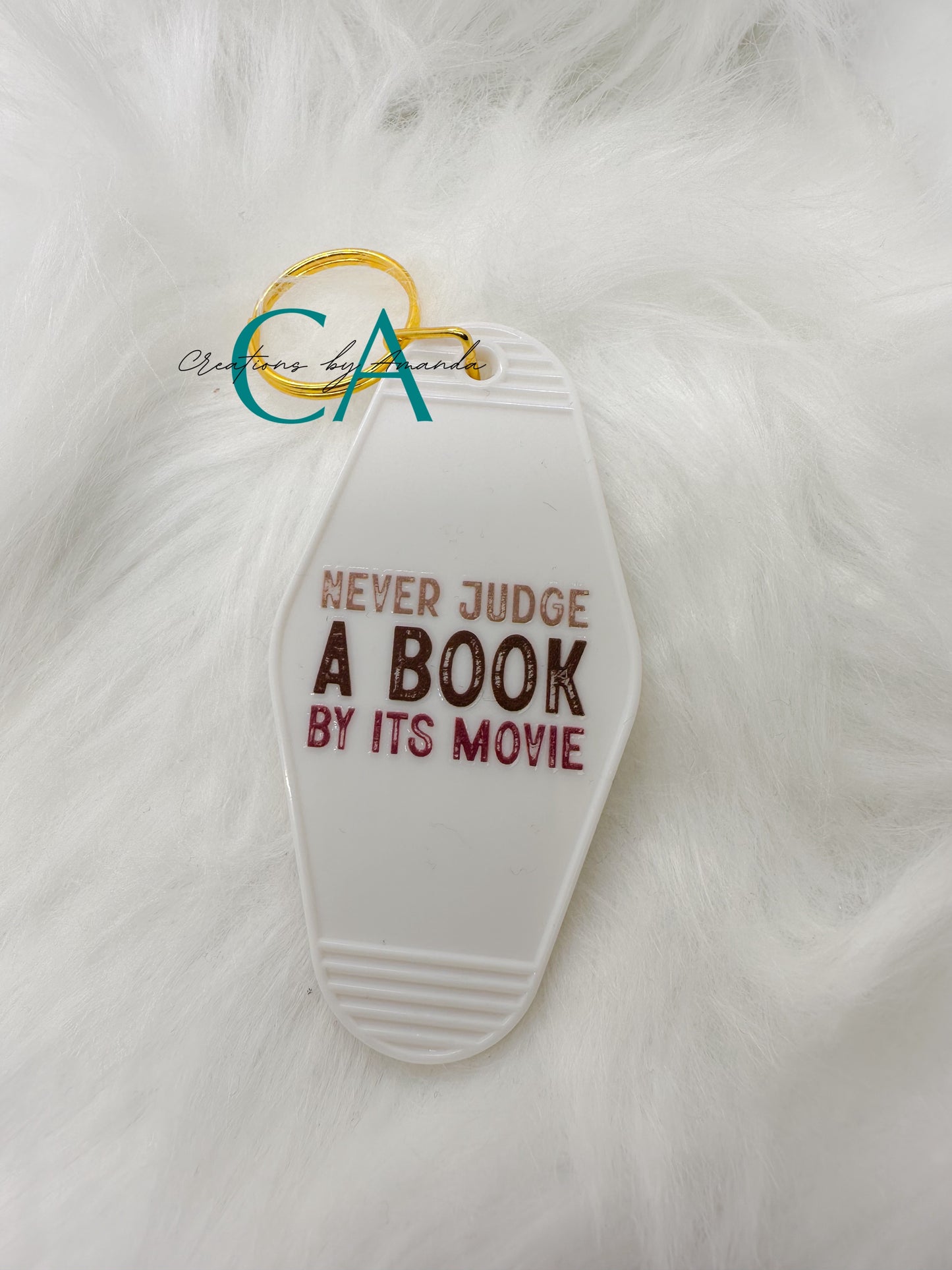 Motel Keychain - Never Judge A Book By It's Movie (White)
